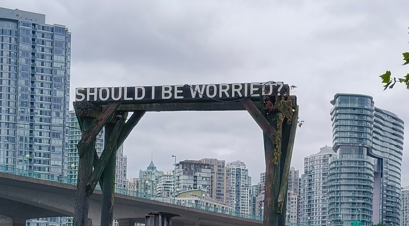 Should I be Worried written on an old train trestle beside Cambie St. Bridge